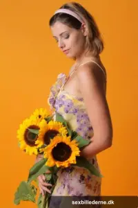 Sexy teen beauty Vienna flaunts her big tits and poses with sunflowers