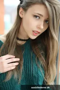 Beautiful teen frees her natural tits from a sweater before spreading her twat